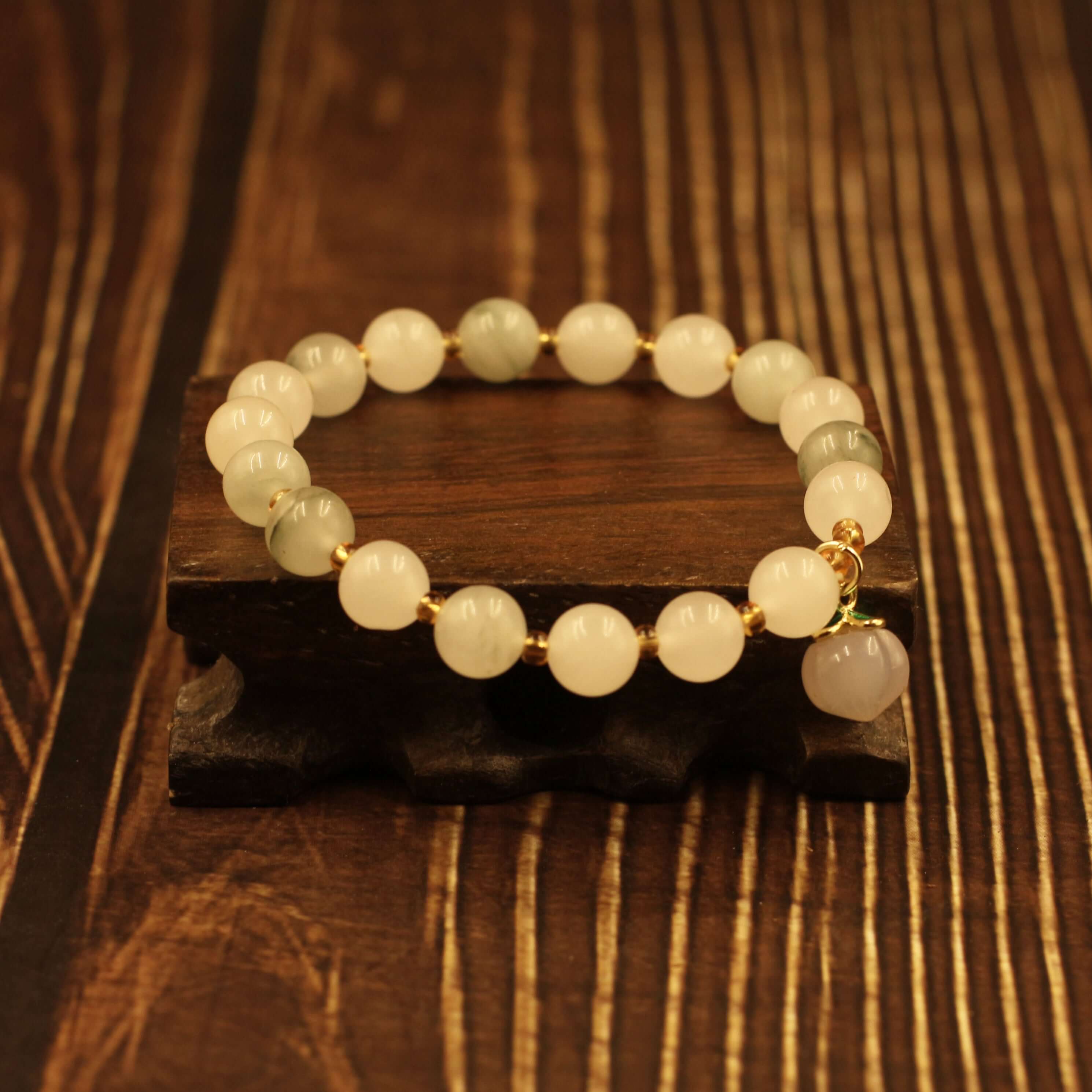 Yanyuan Agate Peach Bracelet on wooden display, promoting health and peace with its unique gemstone textures and rich colors.